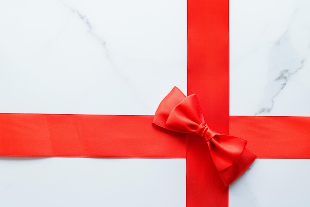 Red silk ribbon on marble top view