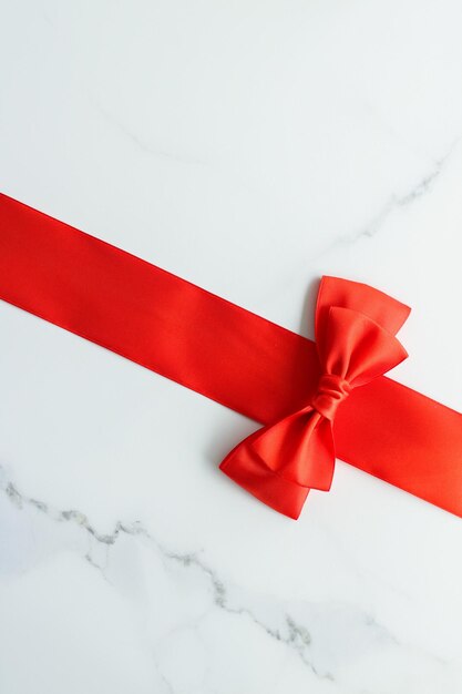 Red silk ribbon on marble top view