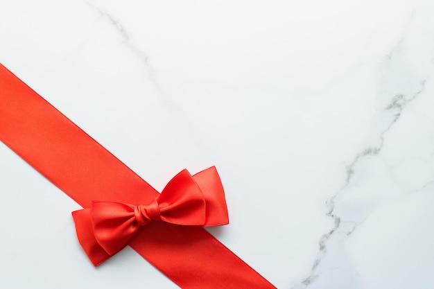 Red silk ribbon on marble top view