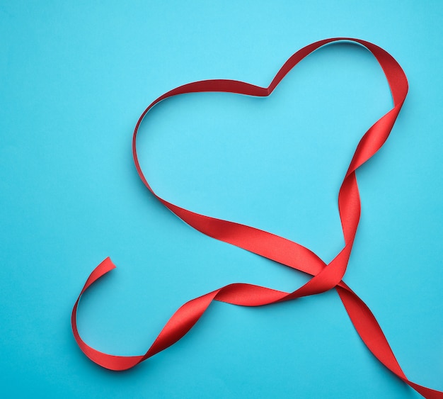 red silk ribbon with shape of a heart