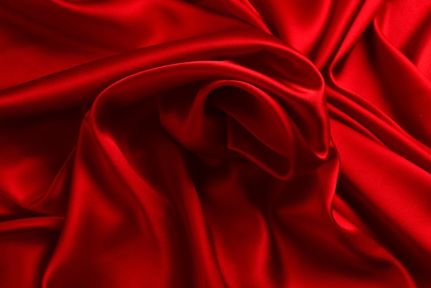 Photo red silk or satin luxury fabric texture can use as abstract background. top view