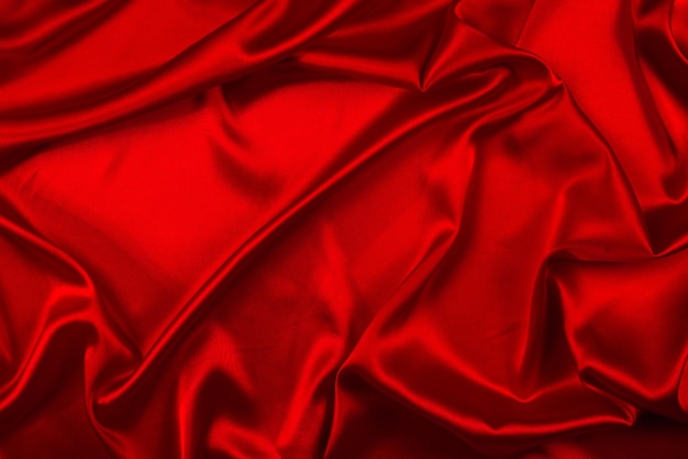 Photo red silk or satin luxury fabric texture can use as abstract background. top view.