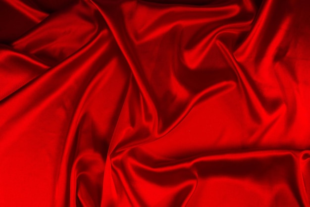 Red silk or satin luxury fabric texture can use as abstract background Top view