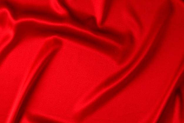 La trama del tessuto di lusso in raso o seta rossa può essere utilizzata come sfondo astratto. vista dall'alto