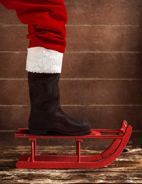 Red sled with the boot of Santa Claus