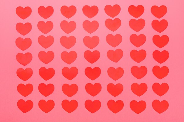 red small hearts pattern on a pink background