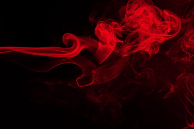 Red smoke abstract on black background for design. darkness concept