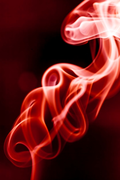 Photo red smoke motion on black background.