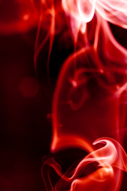 Photo red smoke motion on black background.