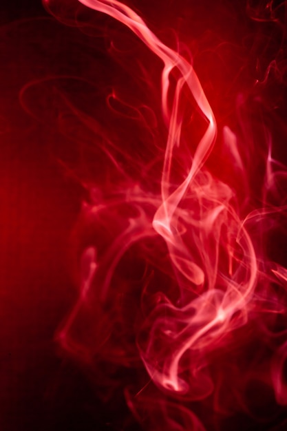Photo red smoke motion on black background.