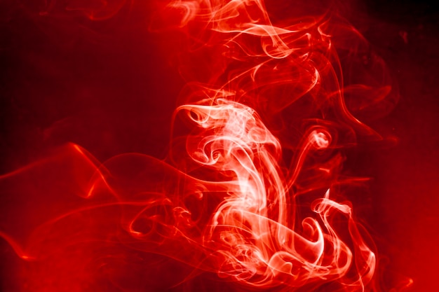 Foto movimento di fumo rosso su sfondo nero.