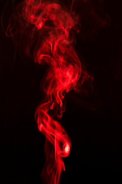 Red smoke swirling against black background