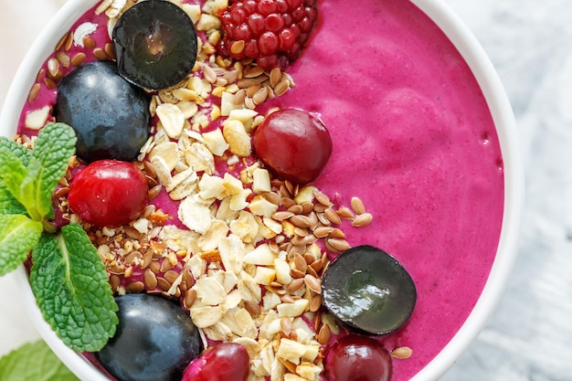 Red smoothie bowl with beets and black grapes