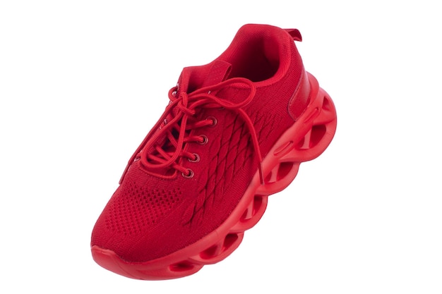 Red sneaker made of fabric on a white background Sport shoes