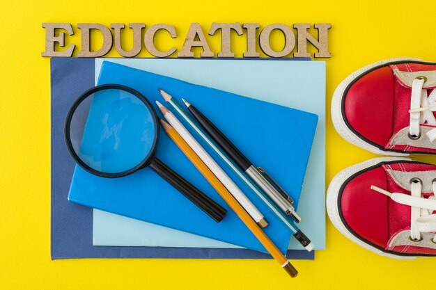 Red sneakers, school supplies, books, notebooks with yellow 