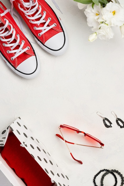 Red sneakers and white flowers on withe background