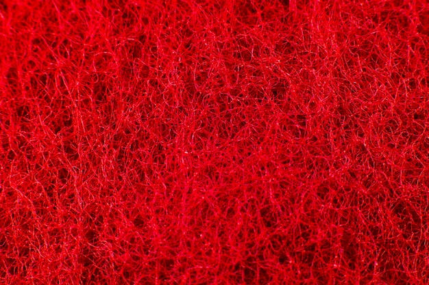 Red sponge texture background. Close up, macro photo.