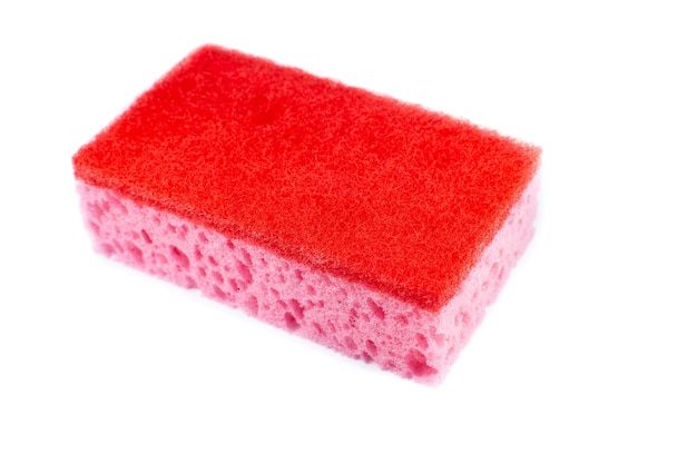 Red sponge for washing dishes on white background. Artificial fiber not eco-friendly tool. Things for kitchen.