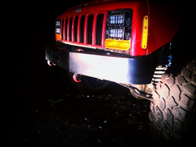 Red sport utility vehicle on road at night