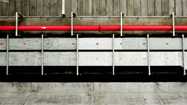 Red steel pipe at cement building.