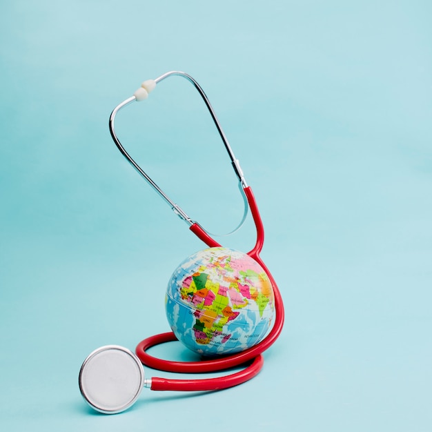 Red Stethoscope on bright pastel blue background