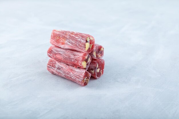 Red sticks Marmalade with sweet sour taste rose and pomegranate Oriental sweets with mix nuts