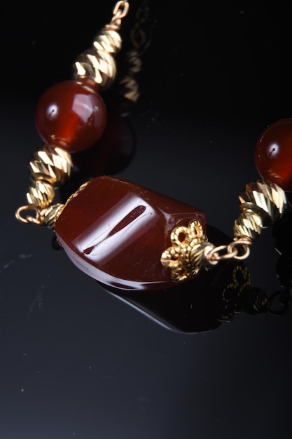 a red stone in gold necklace