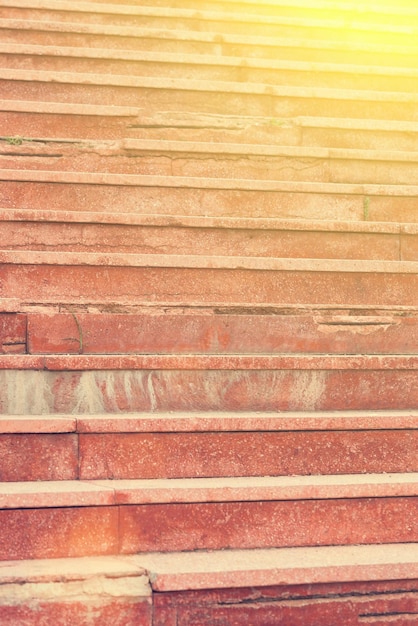 Red stone staircase at sunset or sunrise Close up