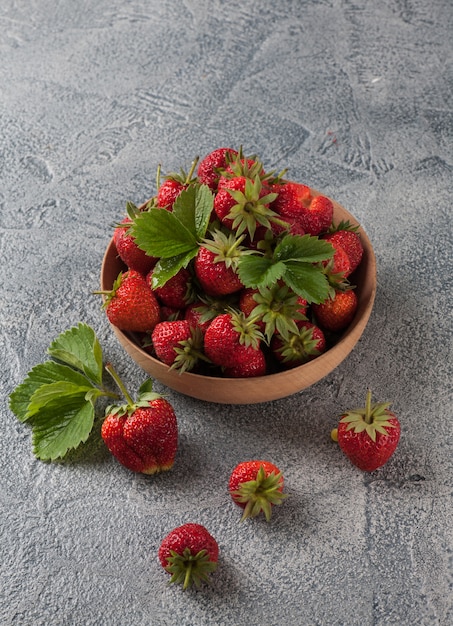 Red strawberies in a wooden bowl