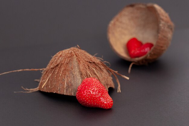 Red strawberries are in the coconut shell and, isolated.