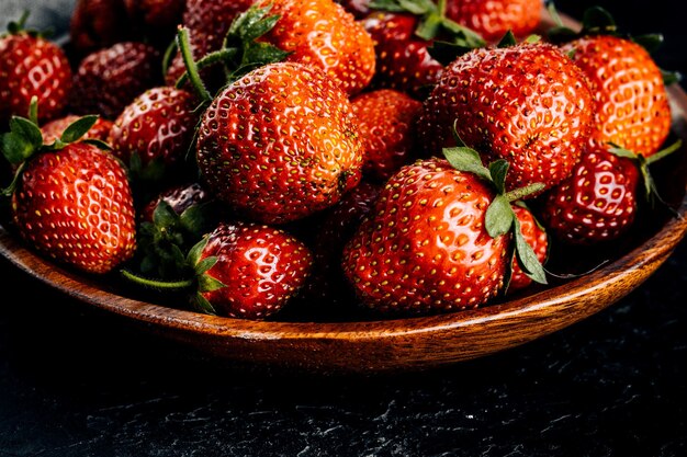 Red strawberries on a dark board