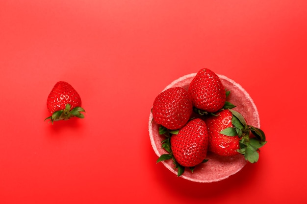 Red strawberries on a red background