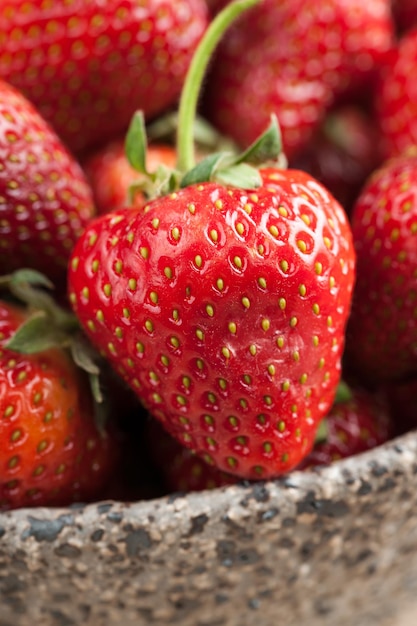 Red strawberry in ceramic bowl close-up