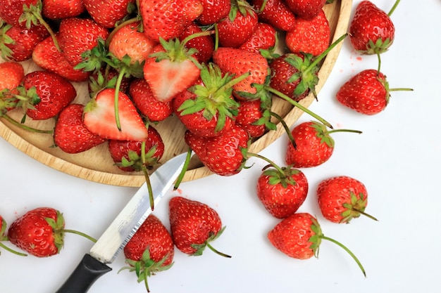 Red strawberry on a wood plate