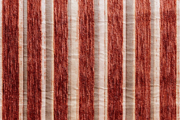 Red striped synthetic woven upholstery fabric closeup texture