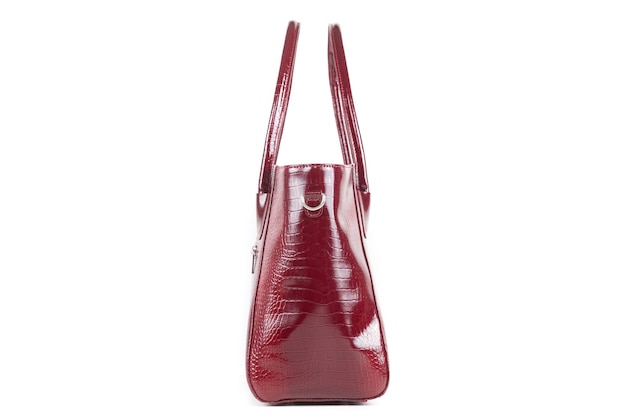 Red stylish ladies leather bag on a white background, side view