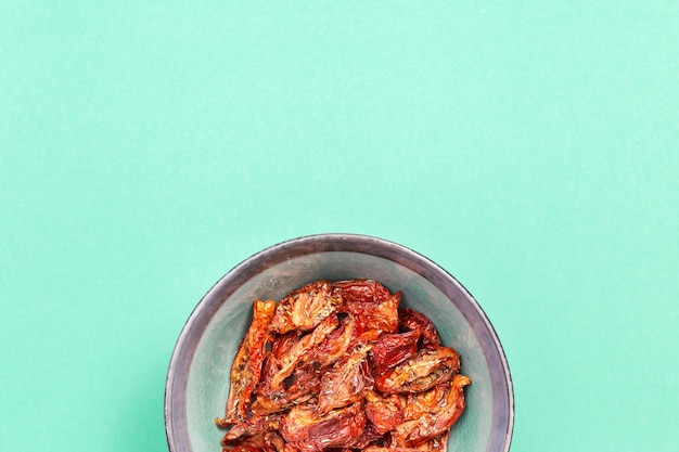 Red sun-dried tomatoes in ceramic plate