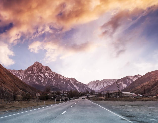 Red sunset panorama with views of military road at sunset