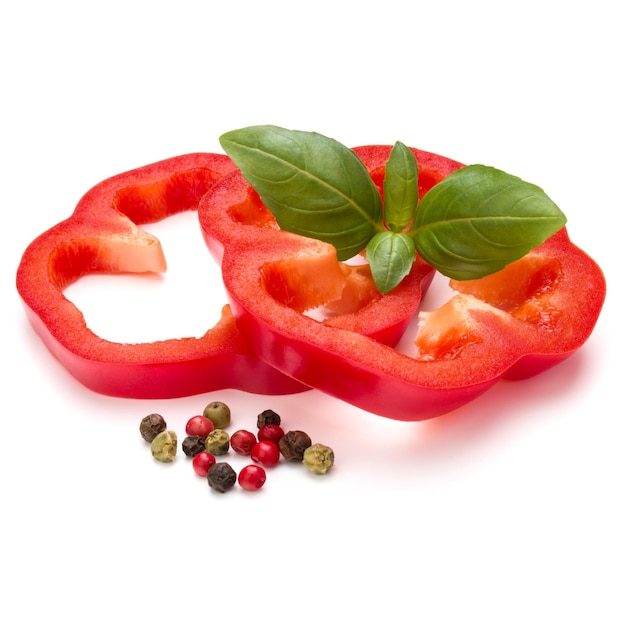 Red sweet bell pepper slices and basil leaves isolated on white background cutout