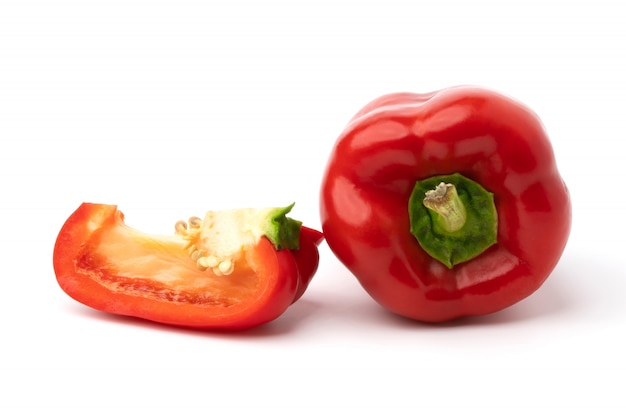 Red sweet bell peppers isolated on white surface