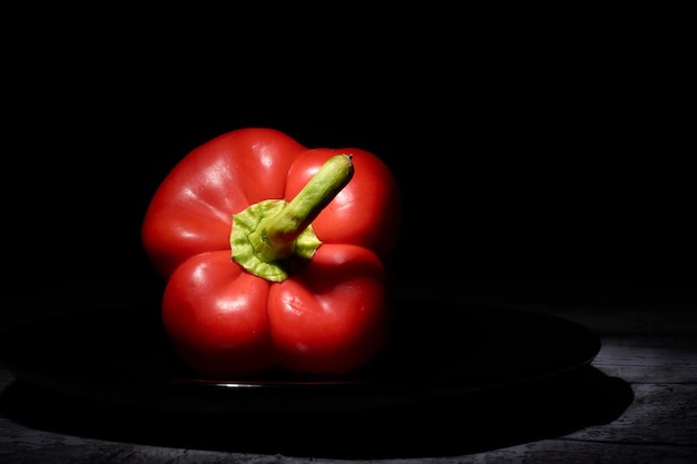 Red sweet pepper on a black background.