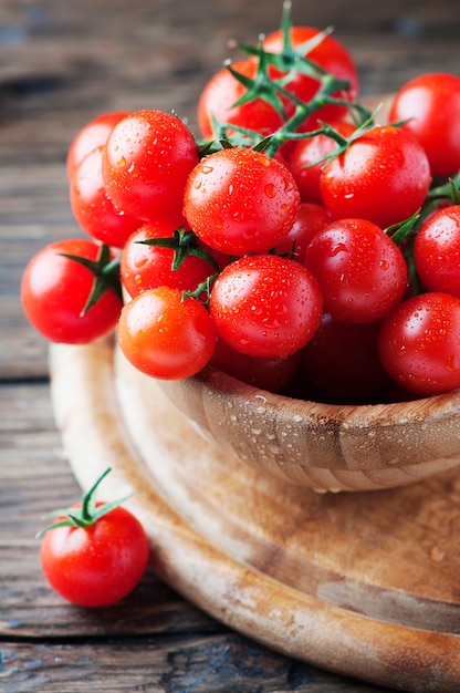 Red sweet tomatoes cherry on the wooden table