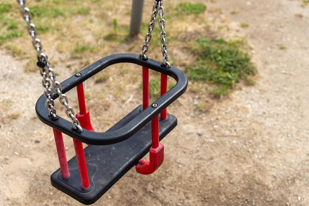 Photo red swing on a children's playground modern