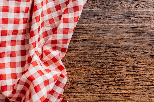 Red table cloth on wooden background