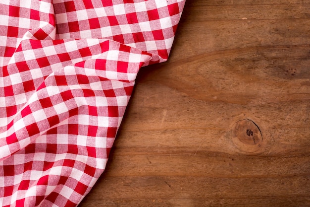 red table cloth on wooden table background