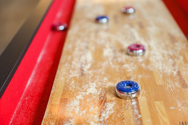 A red table with a blue and red button on it.