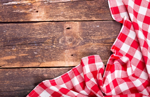 Red tablecloth on rustic wooden table