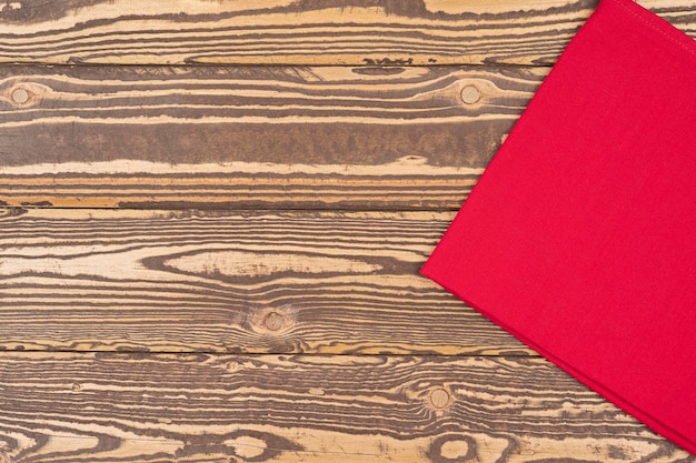 Red tablecloth on wooden table for background Fabric texture Wooden texture of table served of re