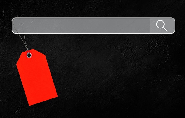 Photo red tag hanging on search engine on black concrete background