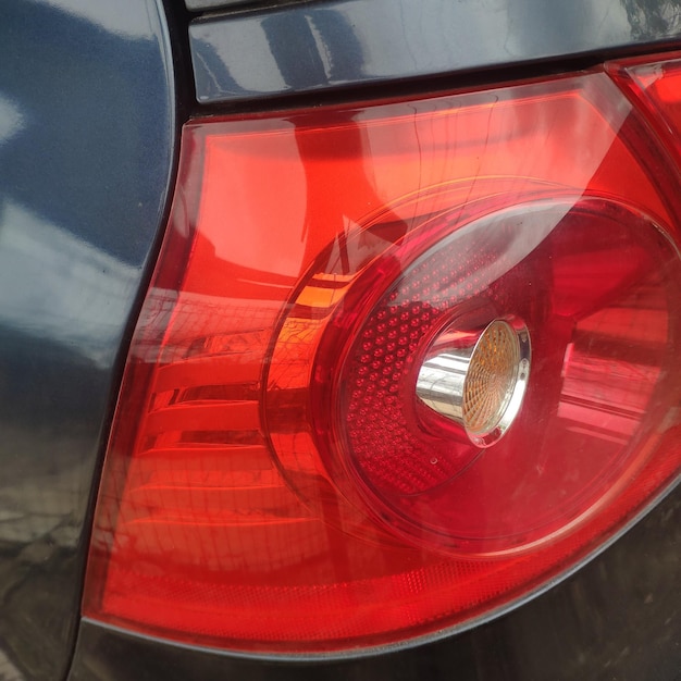 A red tail light that has a light on it